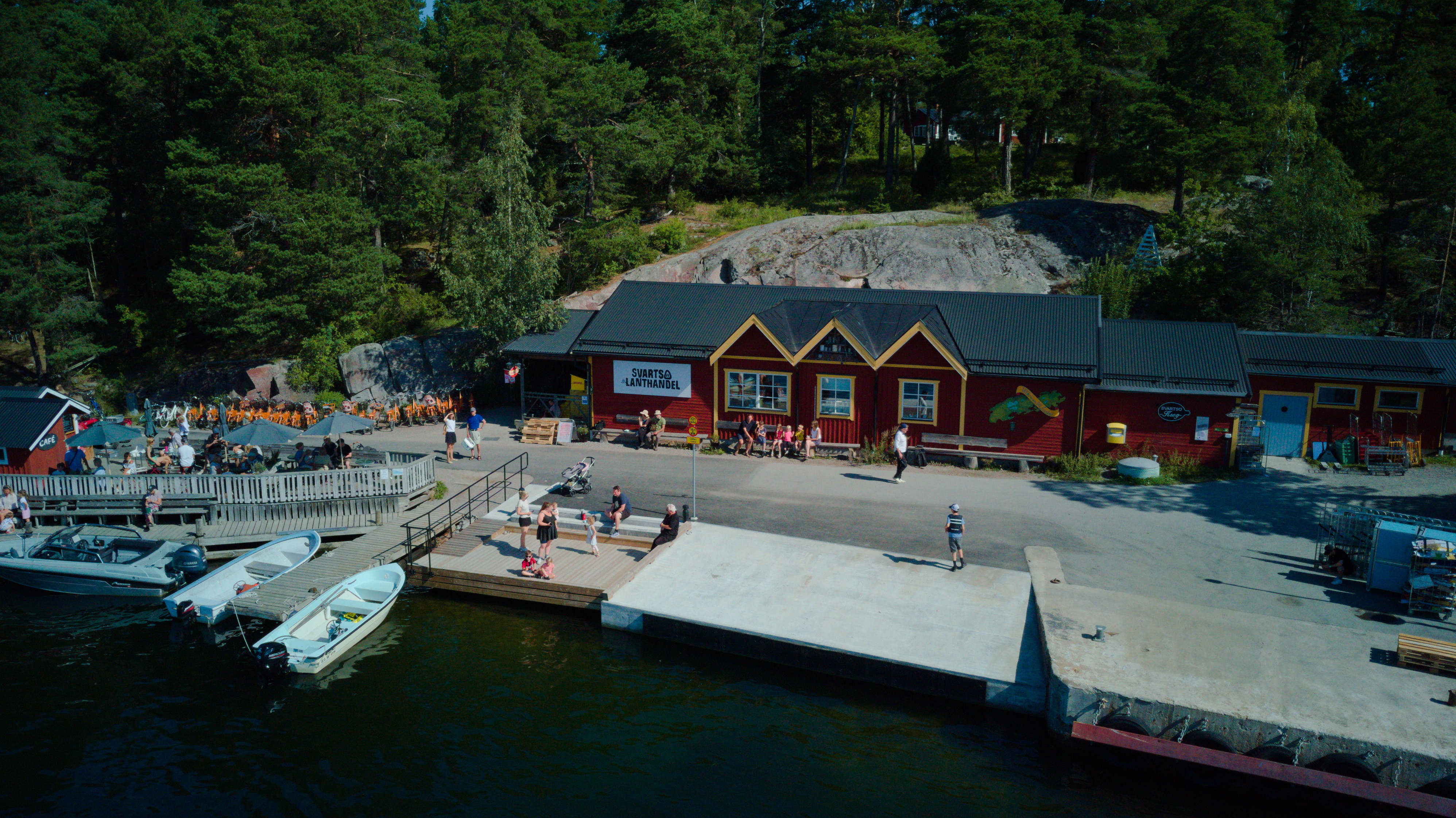 Red waterfront buildings and the guest harbour jetty on Svartsö in the Stockholm archipelago
