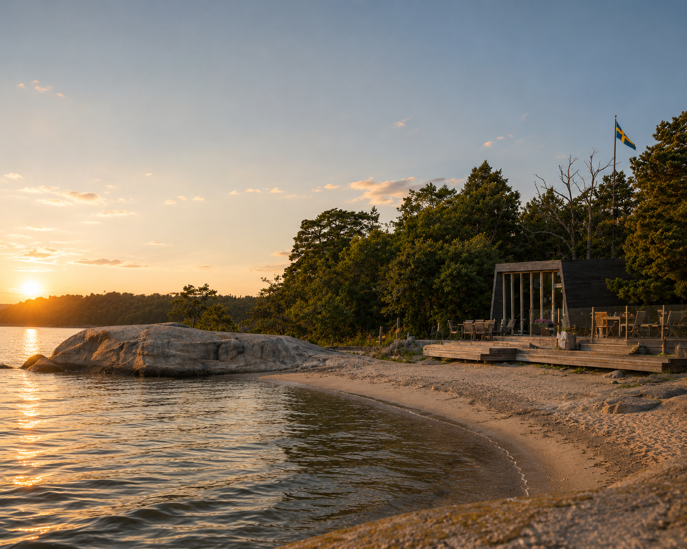 Sandy beach and smooth rock by the water at sunset near Sauna Panorama