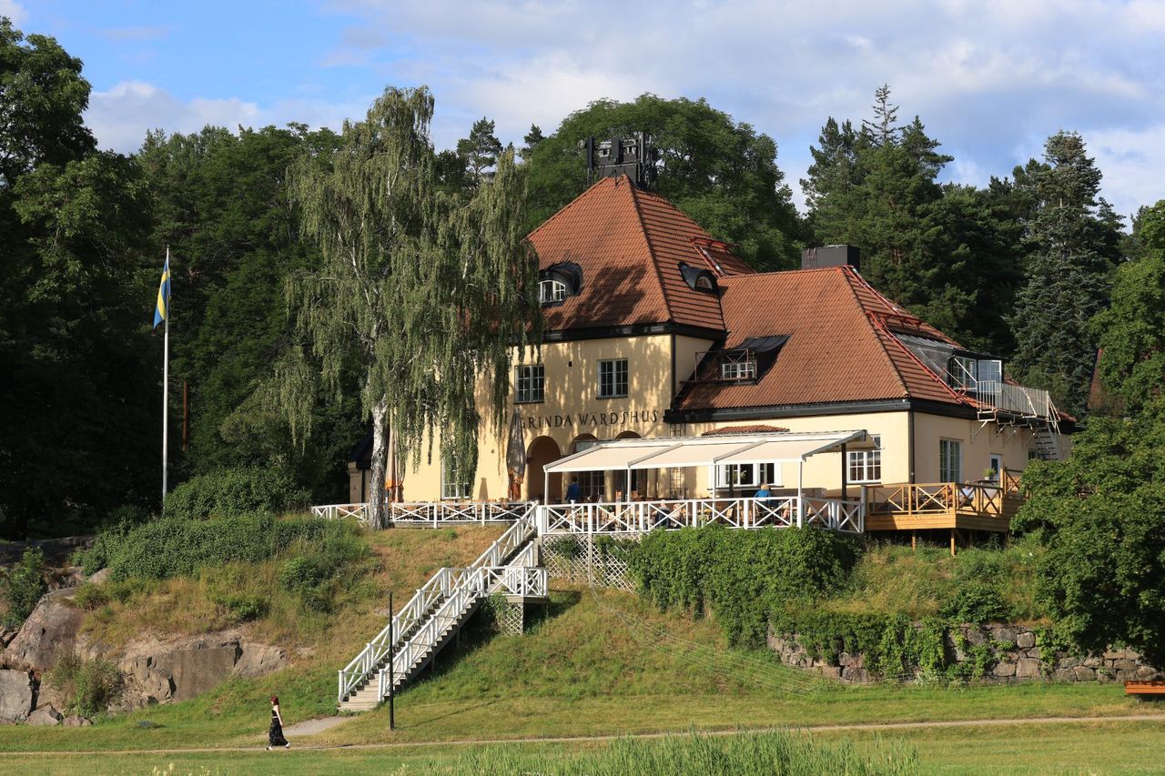 Grinda Wärdshus, a historic yellow inn with a red-tiled roof on a hillside on Grinda