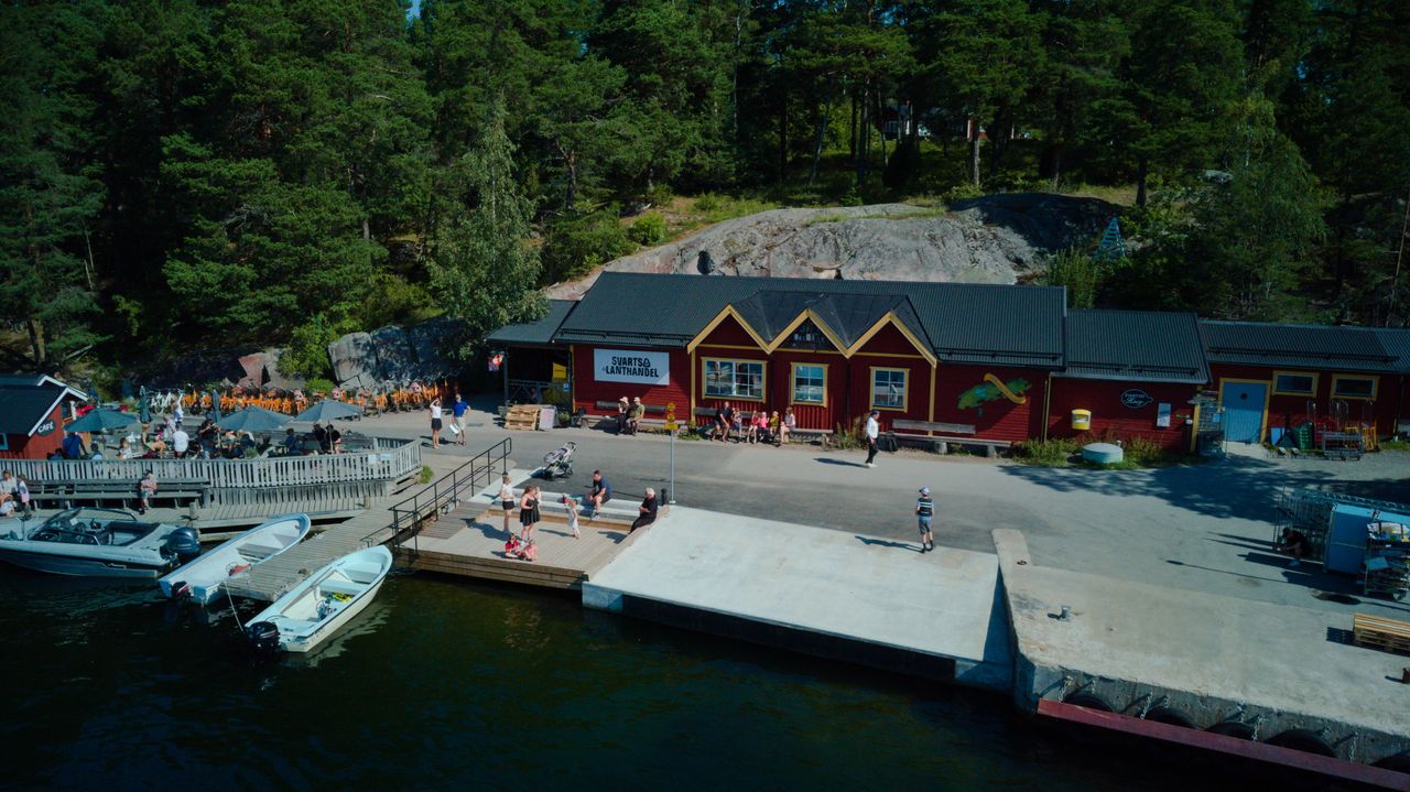 Red waterfront buildings and the guest harbour jetty on Svartsö in the Stockholm archipelago