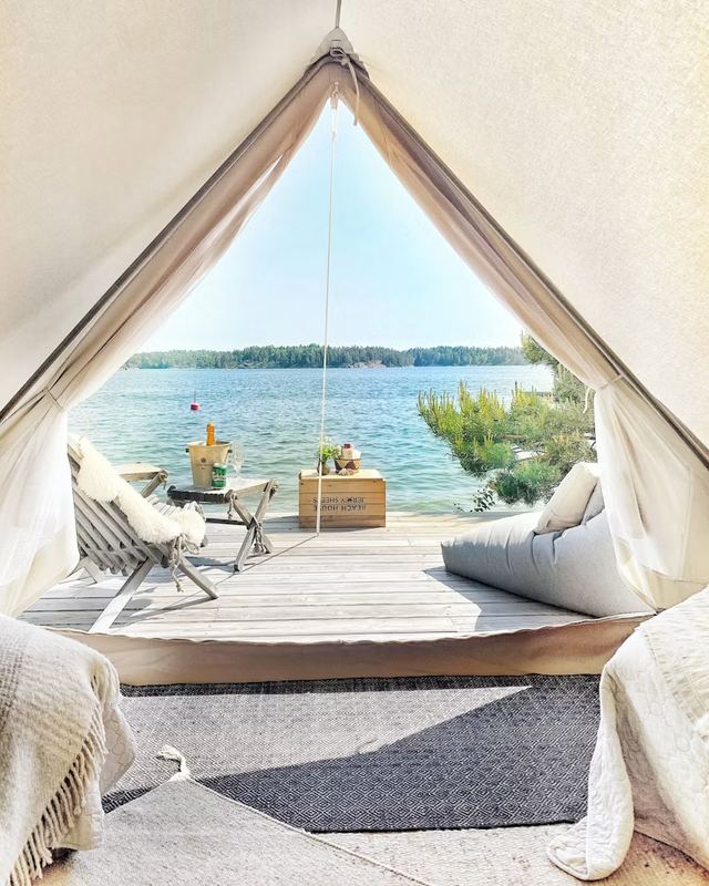 View from a glamping tent over a wooden deck and the sea on Svartsö