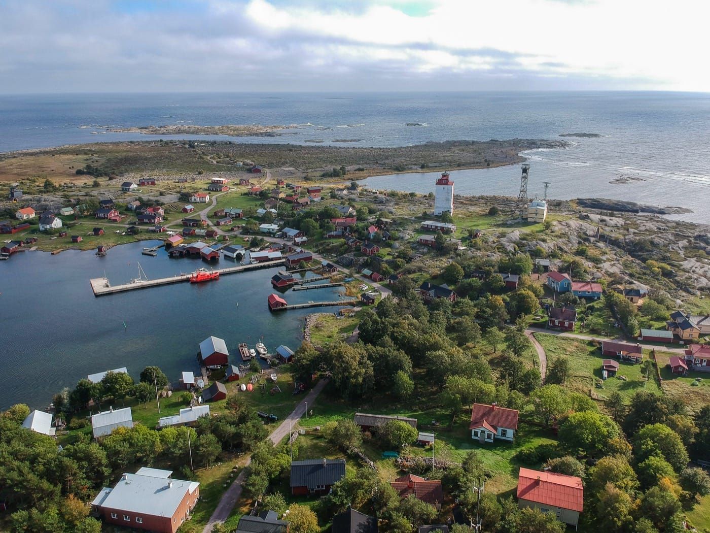 Utö from the air – harbour, jetties, red cottages and the open sea beyond