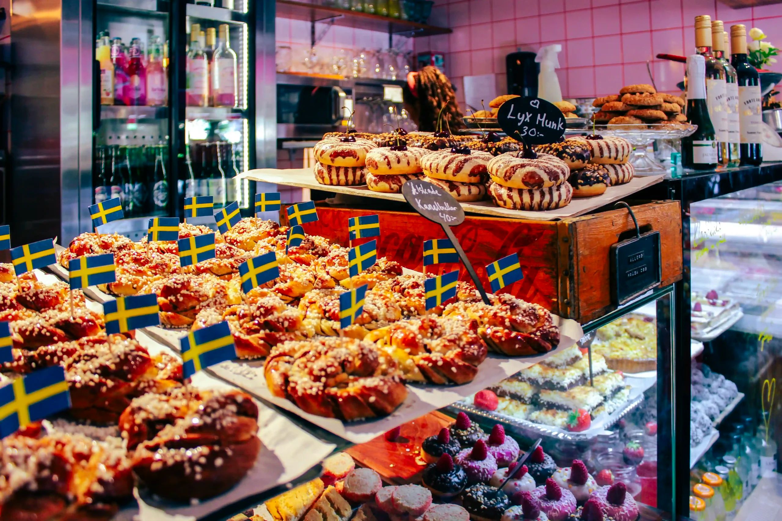 Cinnamon buns and pastries with small Swedish flags in a café display in Vaxholm