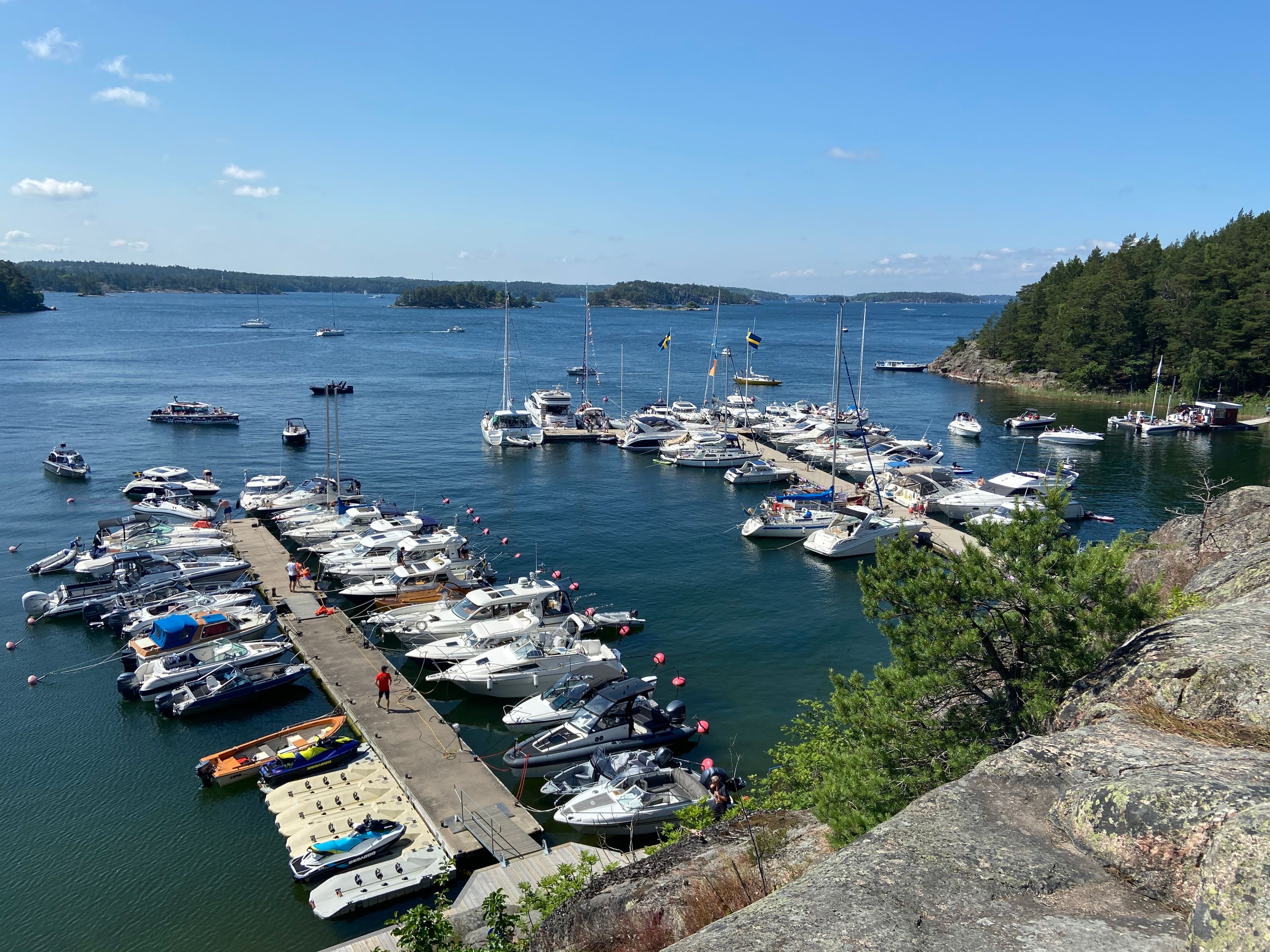 Boats moored along the jetties of Grinda's guest harbour on a sunny day