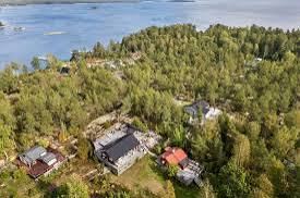 Aerial view of houses among forest by the water on Blidö in the Stockholm archipelago