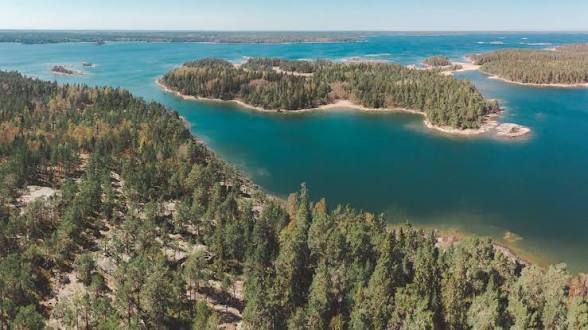 Aerial view of forested islands and turquoise bays around Blidö in the Stockholm archipelago
