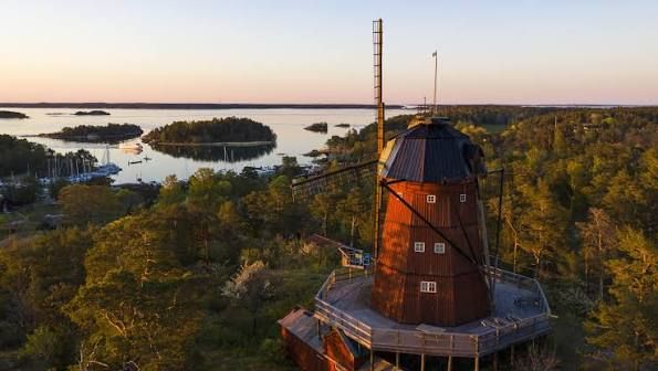 Wooden windmill on Utö at sunset, overlooking forest and archipelago islands
