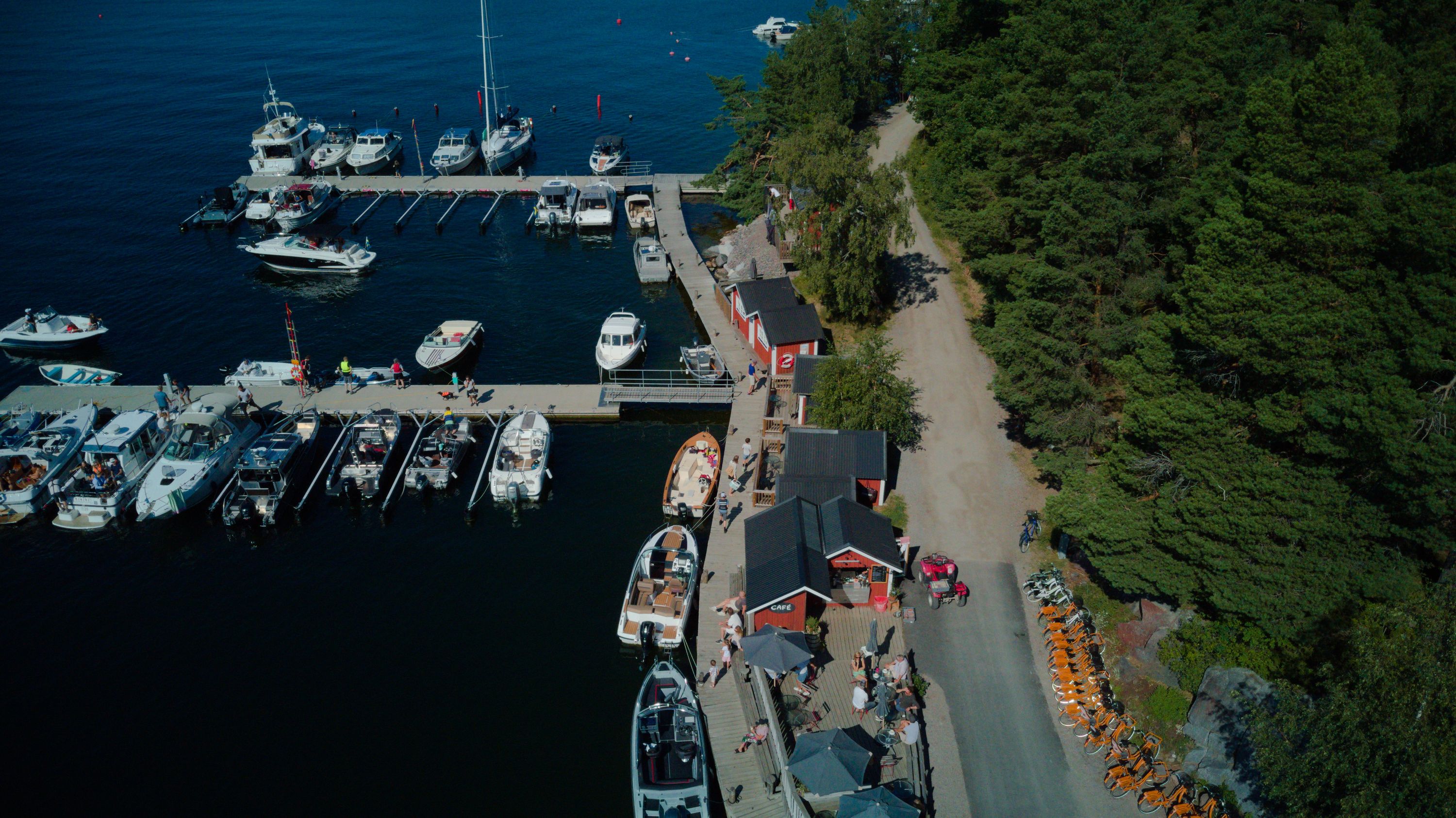Aerial view of the guest harbour on Svartsö, with boats at the jetties beside the forest