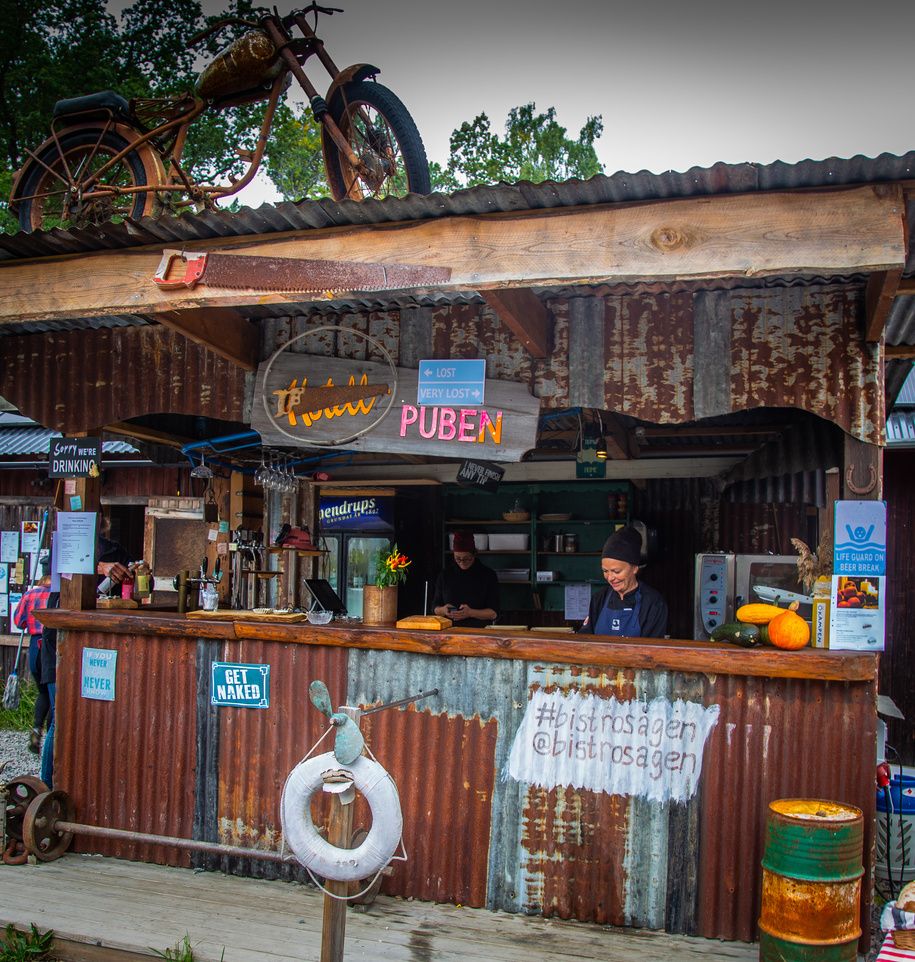 Rustic outdoor pub bar with corrugated metal walls and a lifebuoy on Svartsö