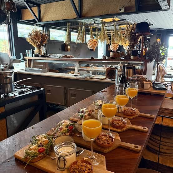 Breakfast boards with orange juice on a long wooden counter in a restaurant at Harö in the Stockholm archipelago