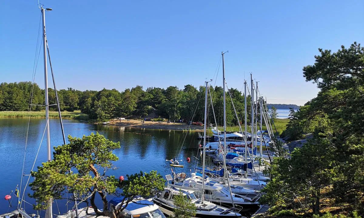 Sailboats and motorboats moored in a sheltered guest harbour on Finnhamn, Stockholm archipelago