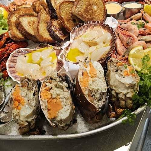 Seafood platter with filled crab shells, scallops, prawns and toasted bread at Motorverkstan Bistro & Bar on Djurö, Stockholm archipelago