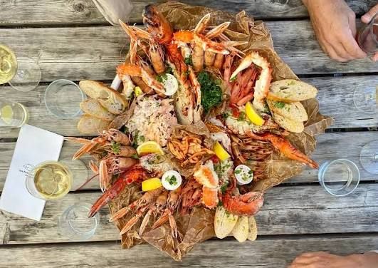 Seafood platter with prawns, crayfish and lemon on a wooden table on Möja