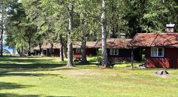 Red wooden holiday cottages among pine trees on Nåttarö in the Stockholm archipelago