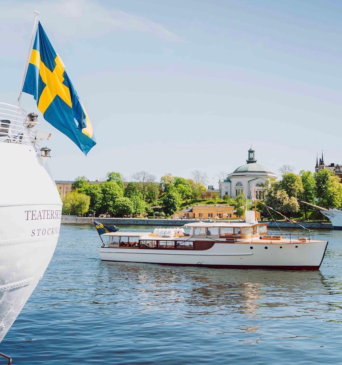 Classic wooden boat Sara passing Skeppsholmen on a private boat tour in central Stockholm